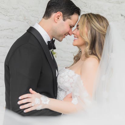 Bride and groom share a tender moment in this intimate wedding portrait